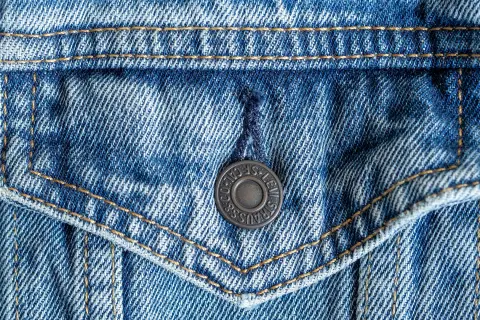 Close up of a denim jacket pocket and stitching